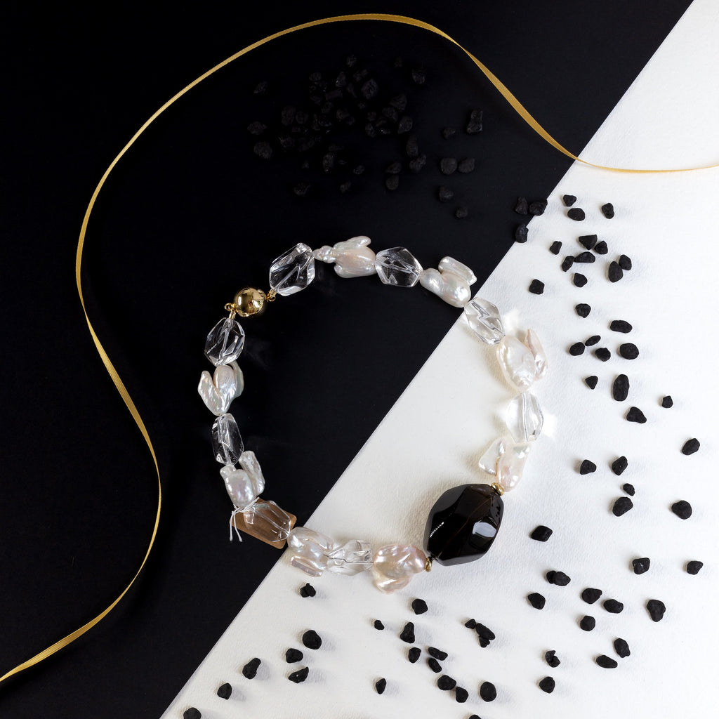 Everybody will notice this oversized smokey and crystal quartz beauties attached with keishi pearls of unexpected shape. Gold plated silver magnetic clasp. It is time to shine!