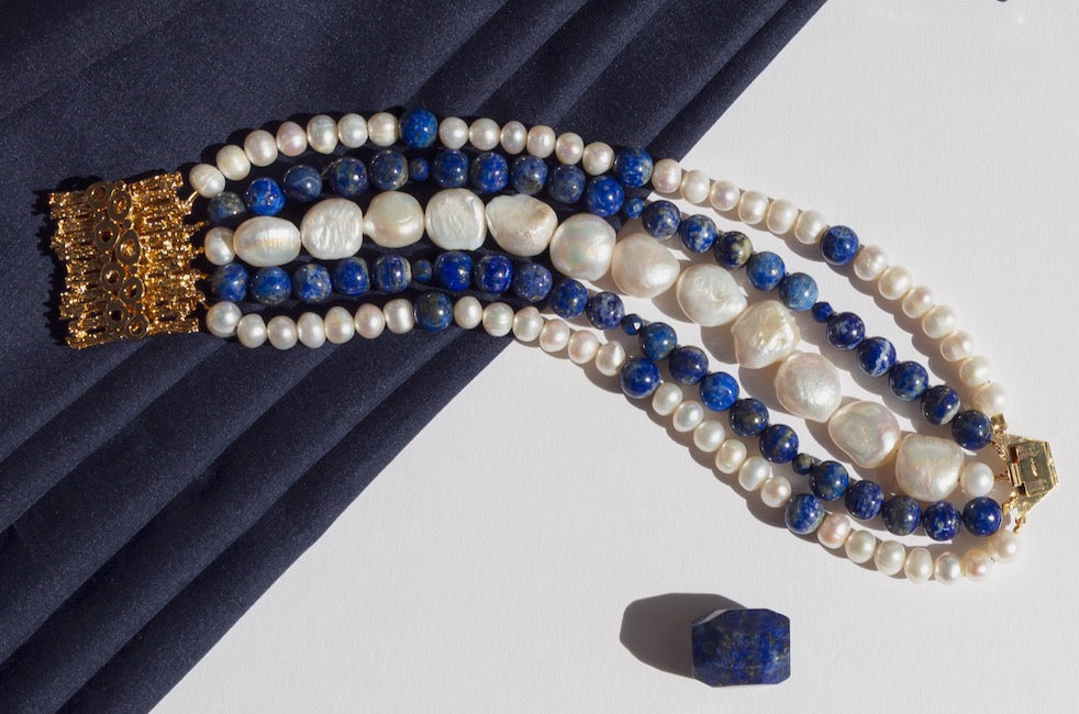The embodiment of elegance, luxury and head turning style with carefully sourced freshwater pearls and lapis lazuli in five raws says: rich and famous. Finished with gold plated silver clasp